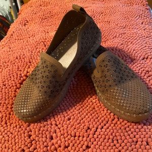 Brown flats with shiny top.